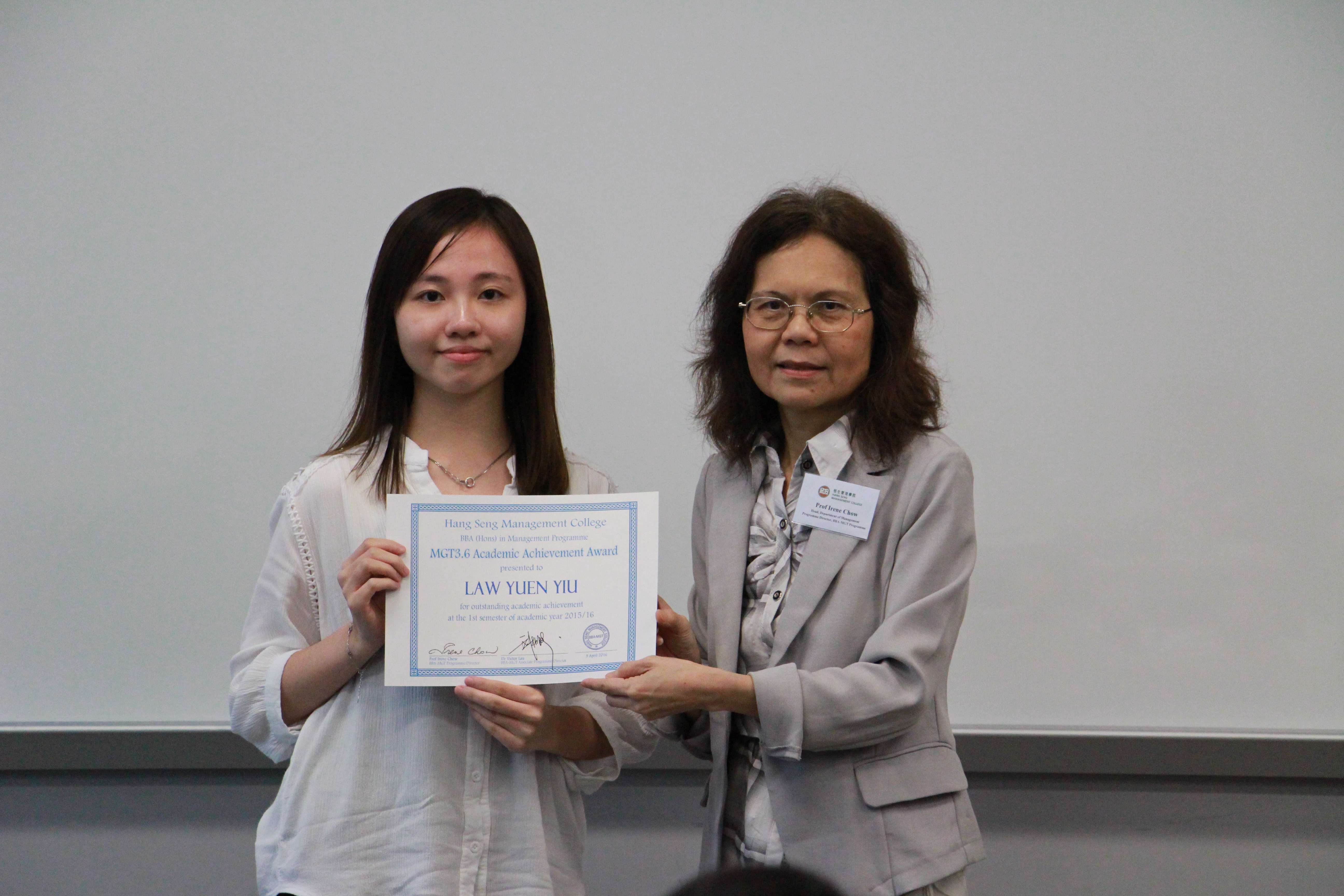 Prof. Chow presents the certificate to the student.